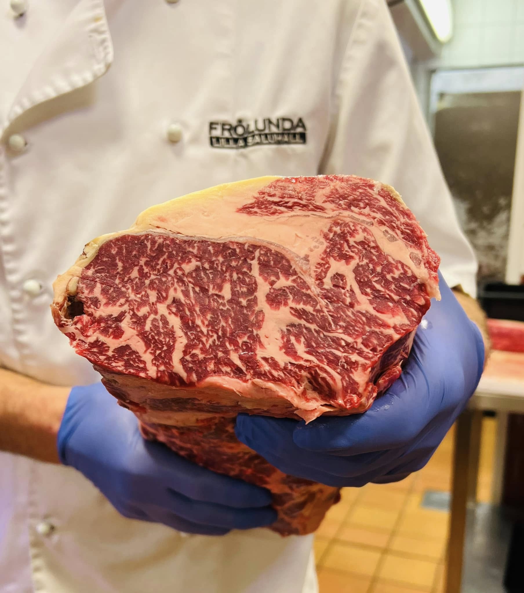Dry aged entrecôte i handen, mognadskammarens skorpa synlig